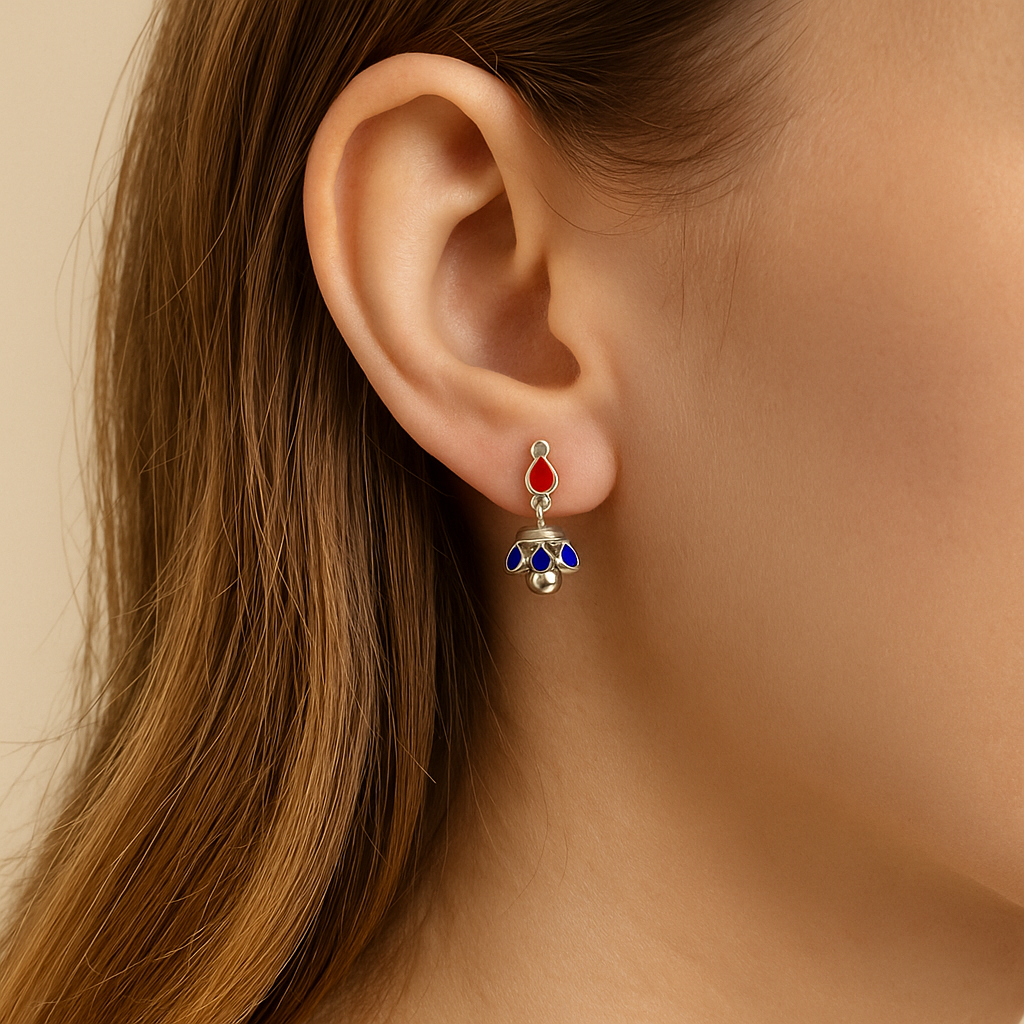 Close-up of an ear wearing a colorful earring with a neutral background